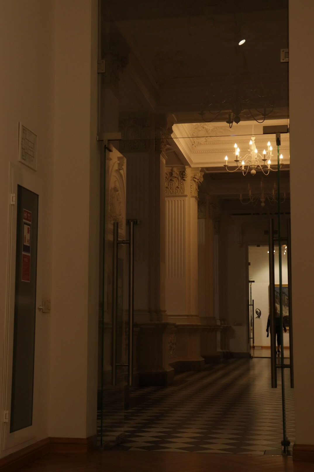 Long museum corridor with high ceilings and warm light