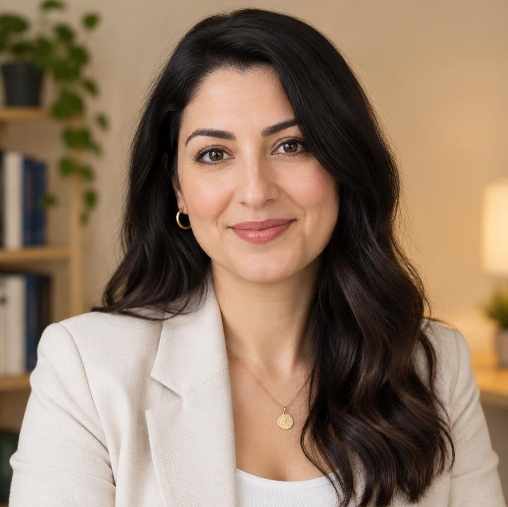 Portrait of a woman in a blazer smiling softly